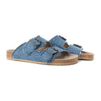 Angled side view of Myra Blue Ridge Denim Sandals showing frayed denim straps and cork-look soles.
