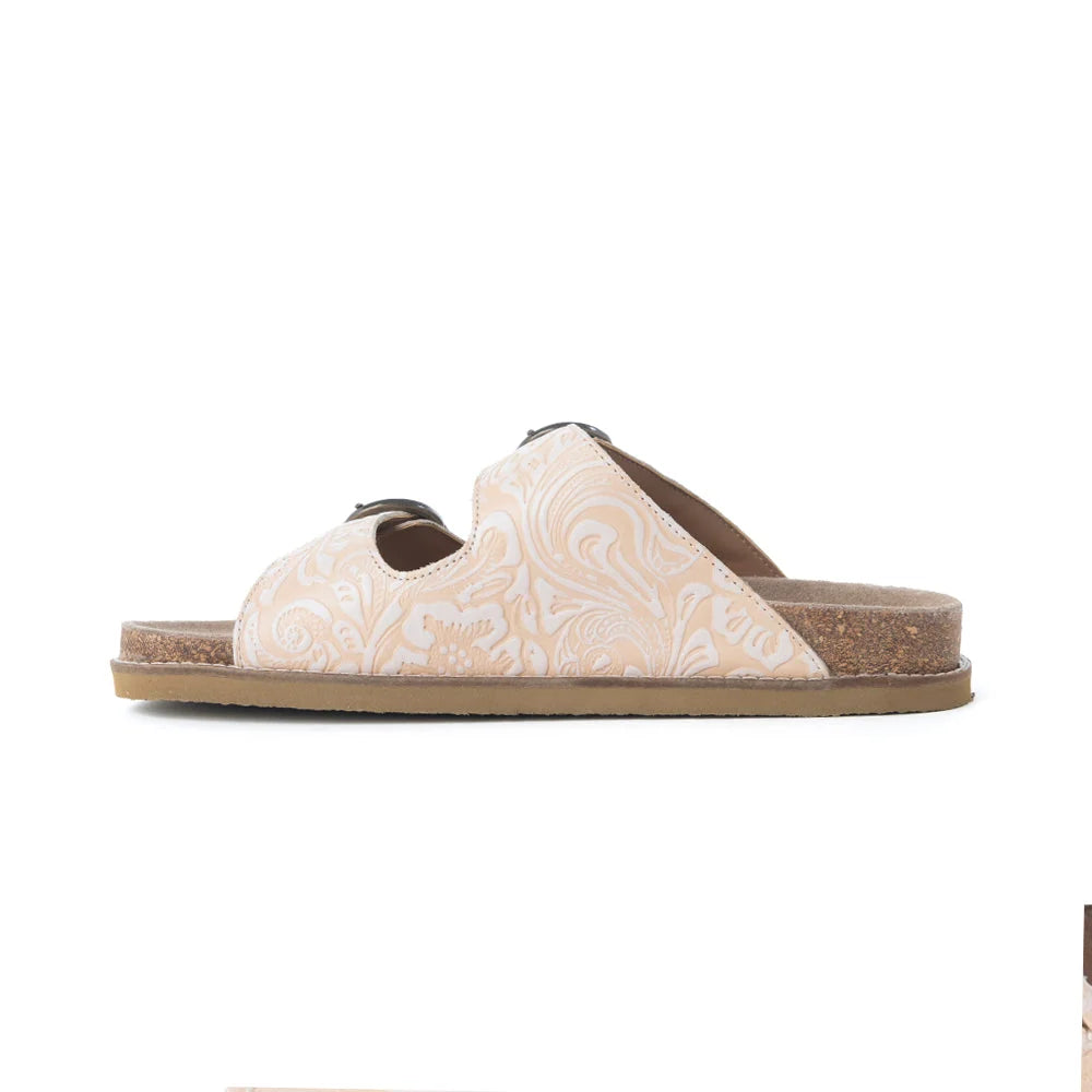 Side profile of Myra Desert Lily Antique White sandal showing embossed leather and cork footbed.