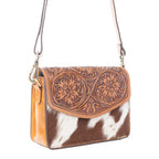 Hand-tooled floral flap bag with natural hairon cowhide