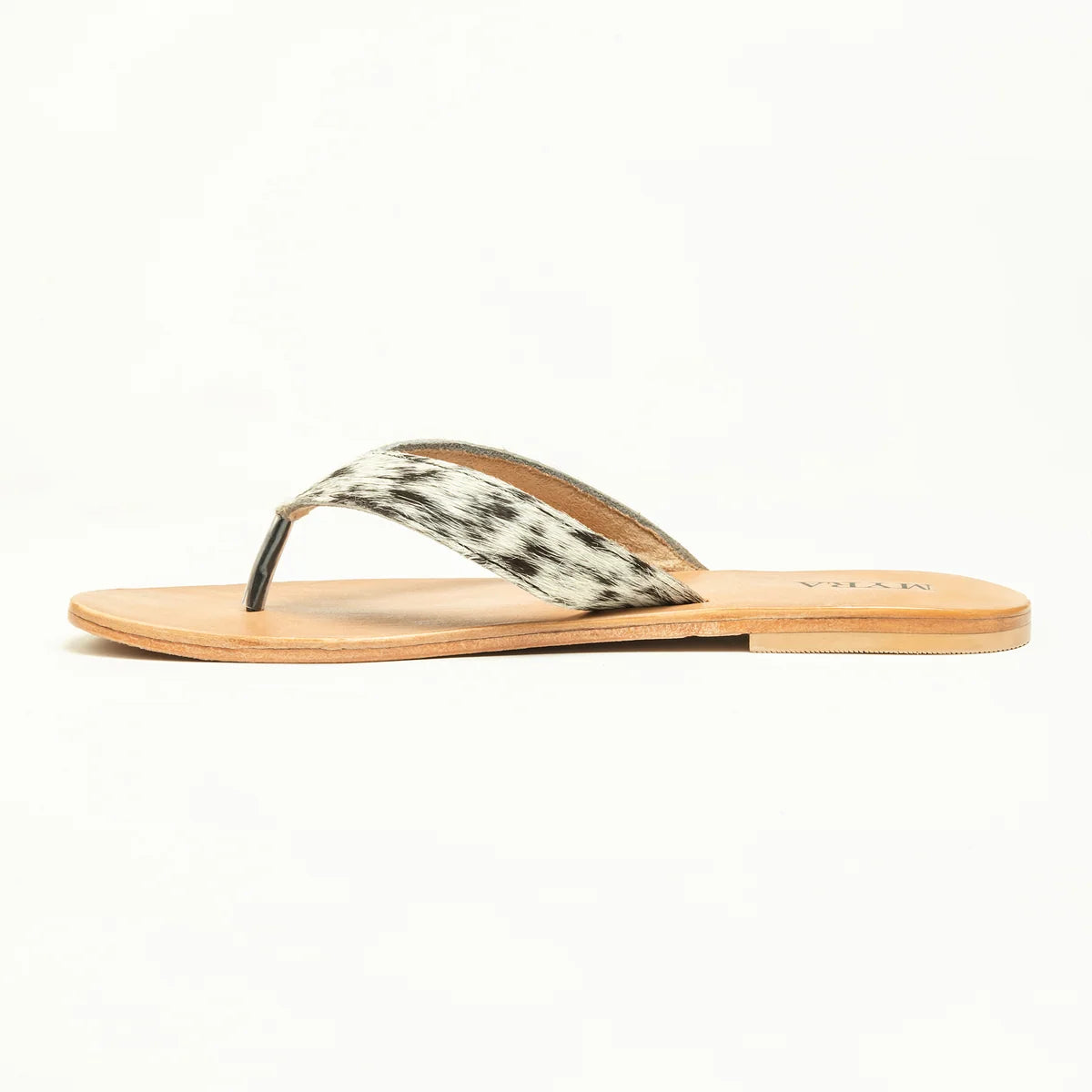 Opposite side view of Myra Echo Valley sandal with spotted ivory strap and tan leather footbed.