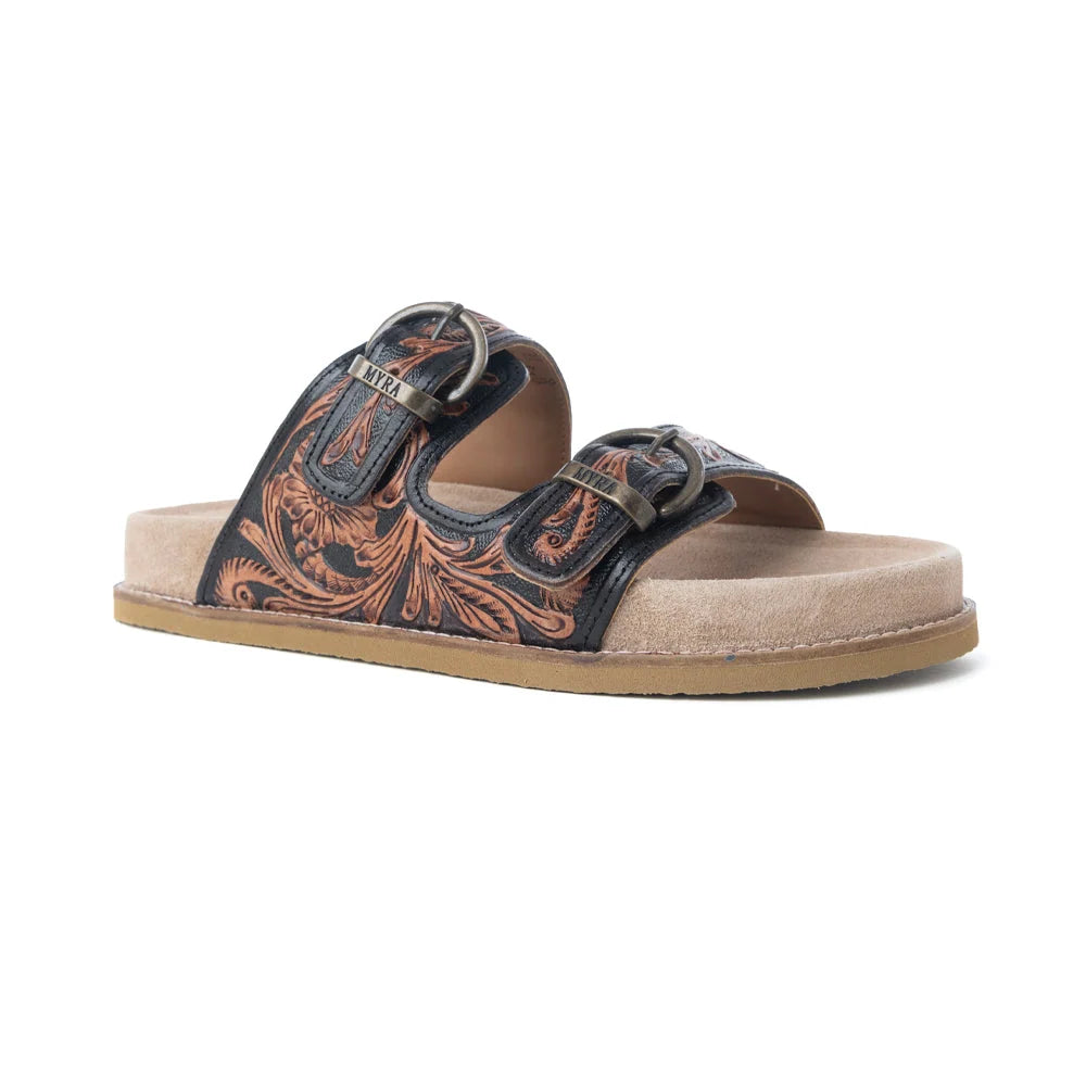 Myra Canyon Ember sandal shown at a low angle, highlighting double buckles, tooled leather straps, and the tan sole.