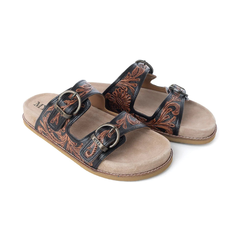 Angled view of Myra Canyon Ember sandals showing brown tooling, metal buckles, and tan footbeds.