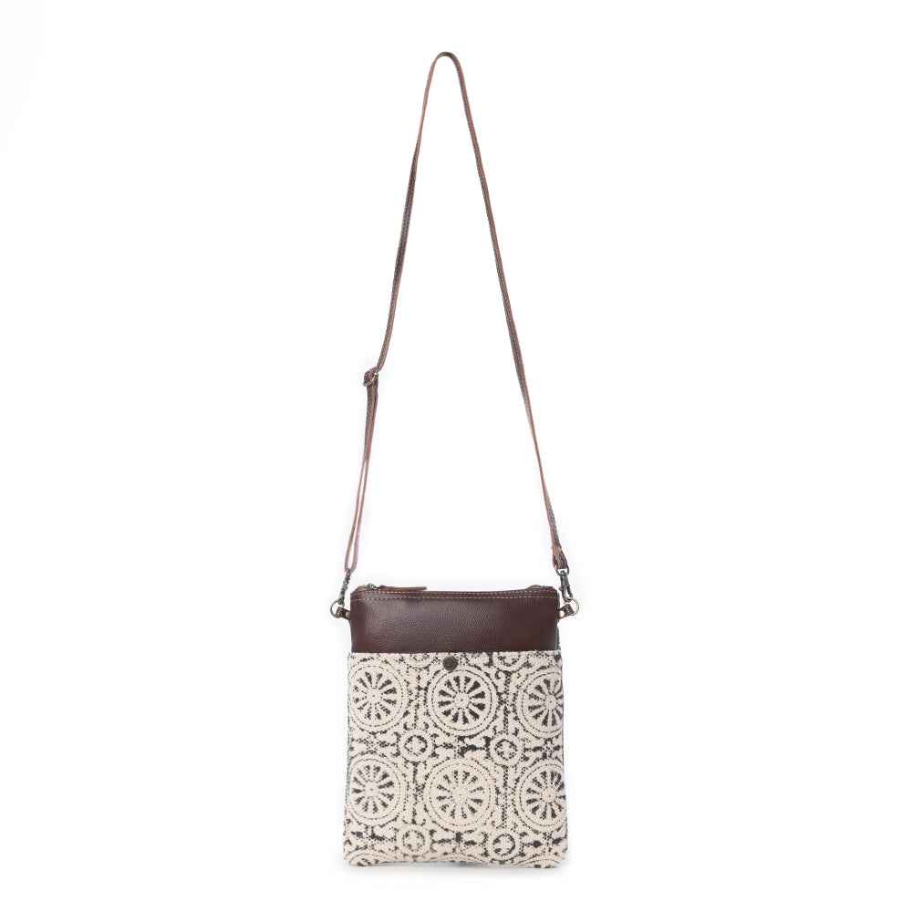 Myra Ruggy crossbody bag shown with its full adjustable brown leather shoulder strap and patterned front.