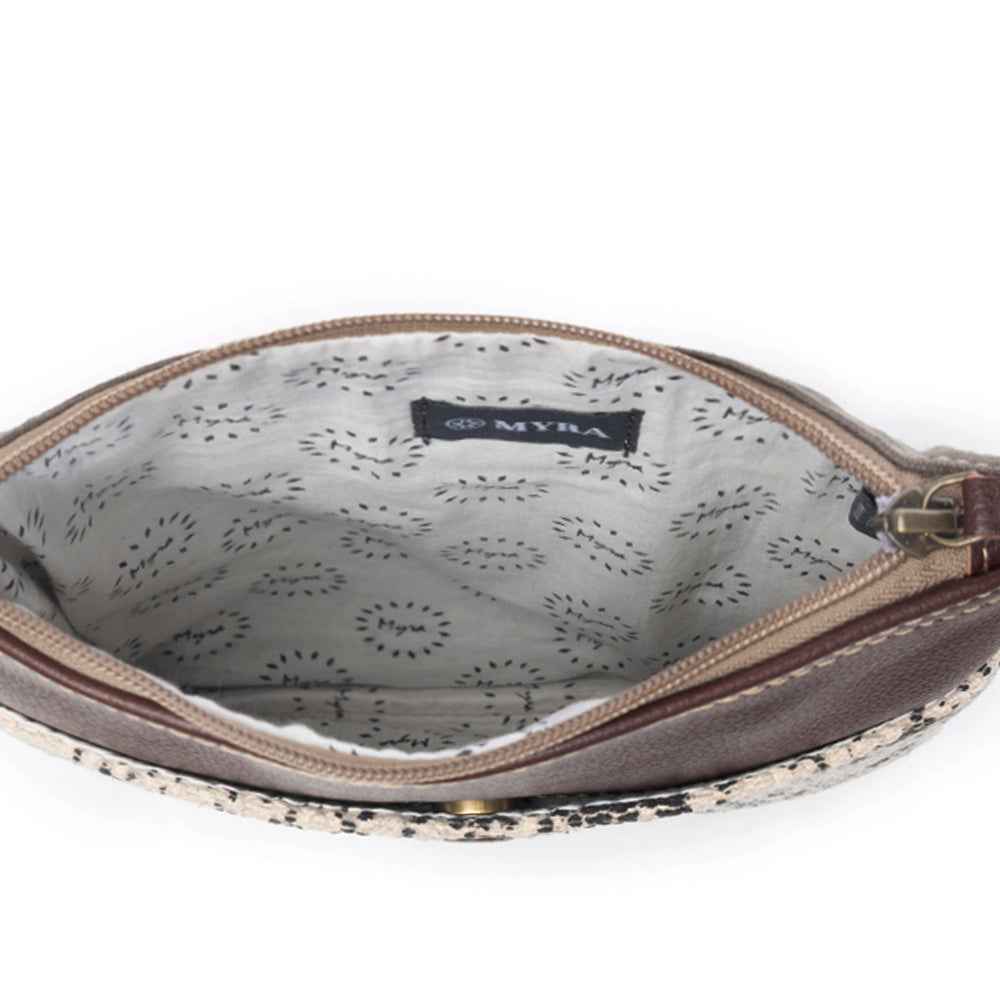 Open Myra Ruggy crossbody bag showing the light patterned lining, Myra label, and zippered top.