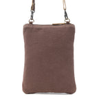 Back of Myra Soul Searcher crossbody bag showing plain brown canvas and detachable strap clips.