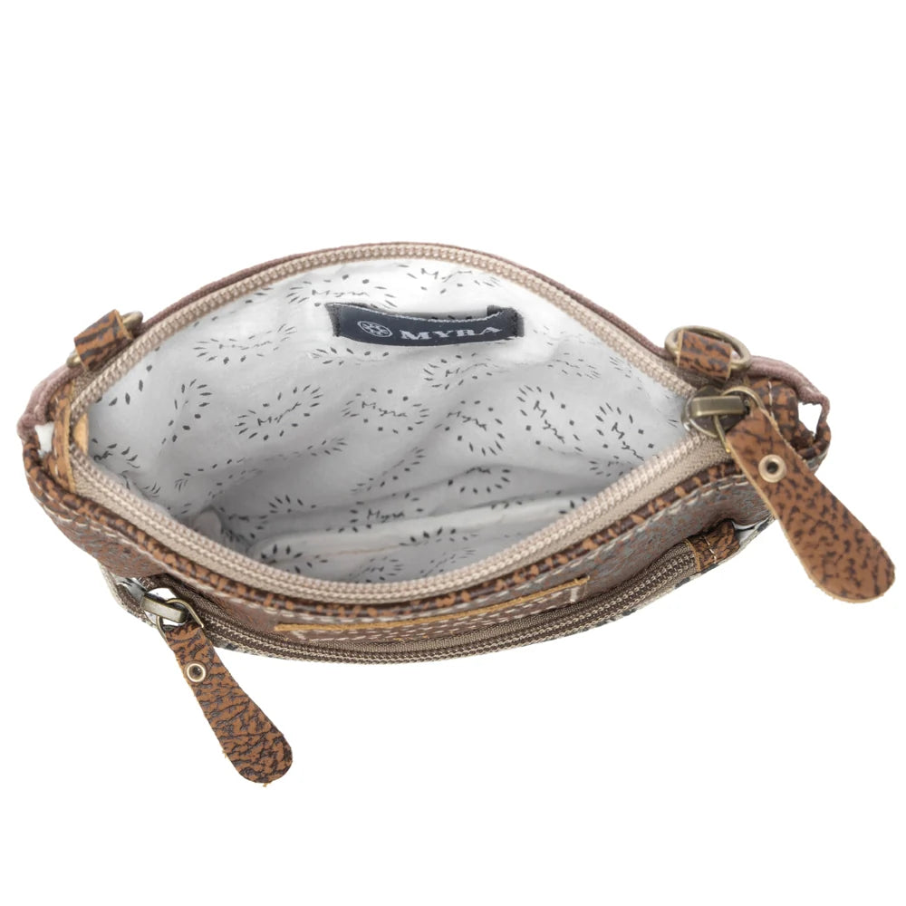 Open Myra Soul Searcher crossbody bag showing light patterned lining, interior slip pocket, and top zipper closure.