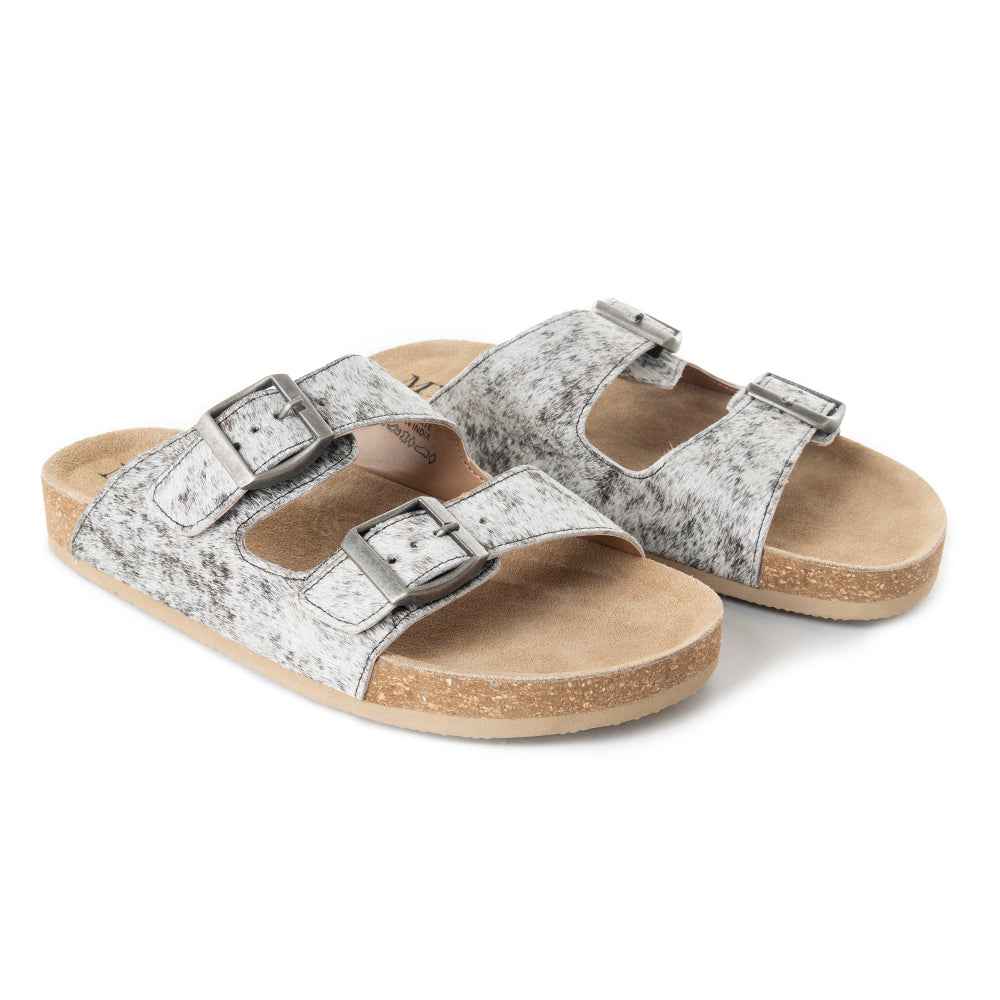 Angled view of Myra Lazy Days cowhide sandals showing double buckle straps and tan footbeds.