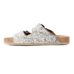 Side view of a Myra Lazy Days sandal showing the hair-on cowhide upper, open heel, and tan sole