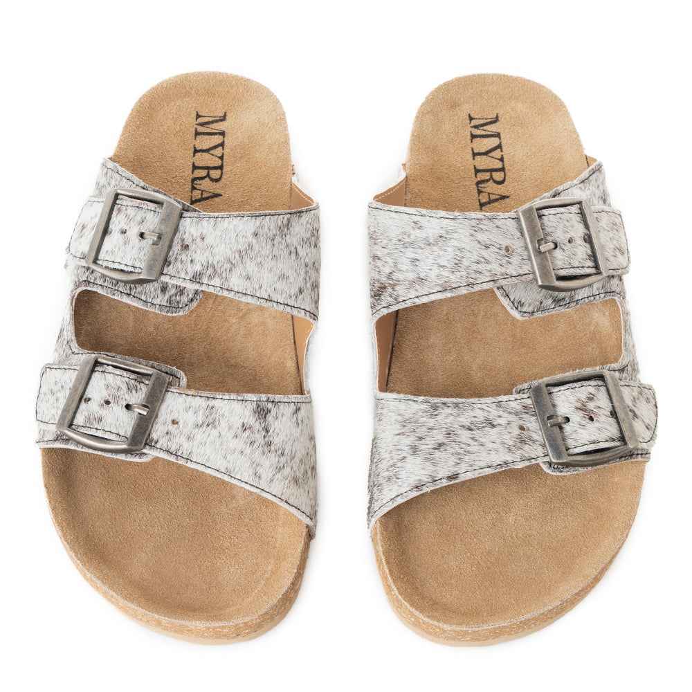 Myra Lazy Days Sandals with black-and-white cowhide straps, silver-tone buckles, and tan footbeds, top view.