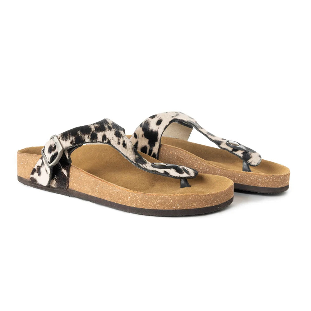 Pair of Myra Chino thong sandals with black and white hair-on cowhide straps and cork soles, angled side view