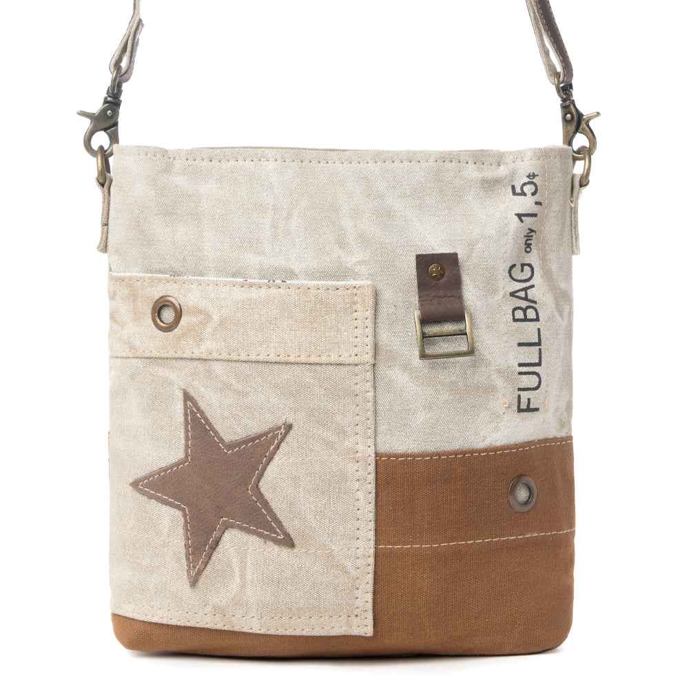 Front view of Myra Leather Star Crossbody Bag with beige upcycled canvas, brown leather star detail and exterior pocket