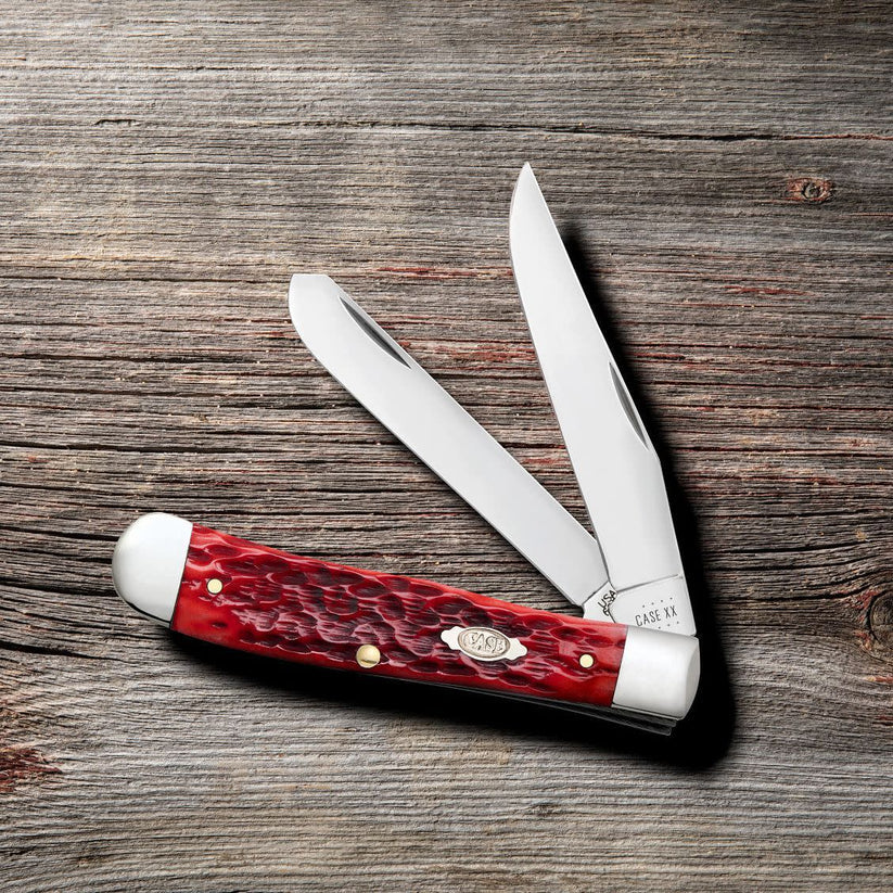 Case Peach Seed Jig Dark Red Bone CS Trapper knife with both blades open on wood