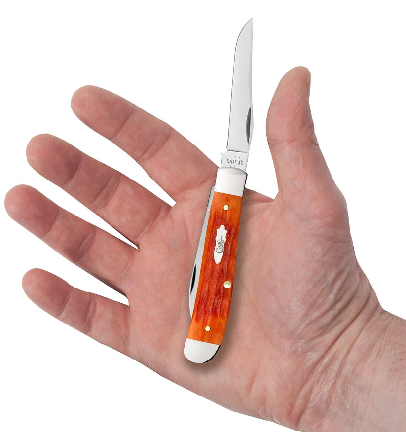 Open Case Tequila Sunrise Bone Mini Trapper resting in a hand for size comparison