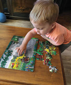 Child assembling the Red Tractor farm tray puzzle with large pieces