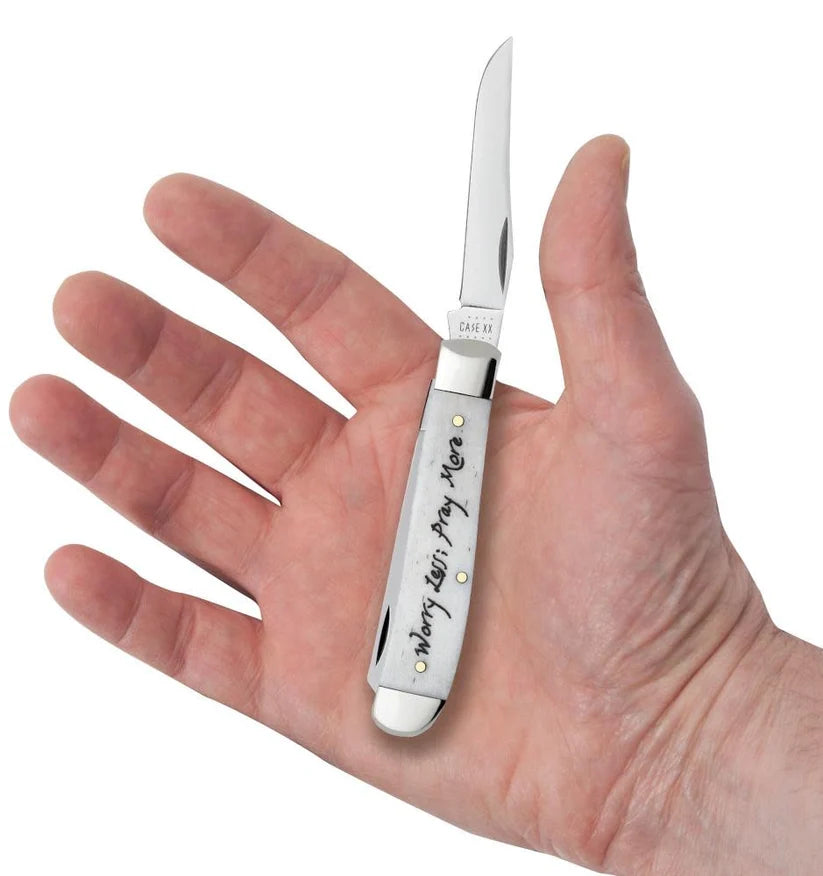 Case Worry Less, Pray More Mini Trapper pocket knife held in a hand with one blade open, showing its pocket size