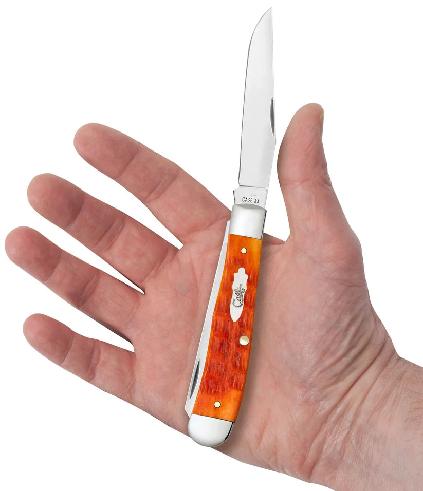 Open Case Tequila Sunrise Bone Trapper resting in a hand for size comparison