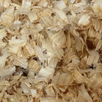 Close-up of large-flake kiln-dried pine shavings for Queen Horse Bedding King Flake.”