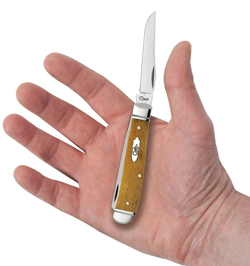 Case Smooth Antique Bone Mini Trapper pocket knife held in a hand with Clip blade open