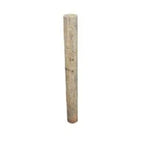 Single treated round wood fence post on a white background